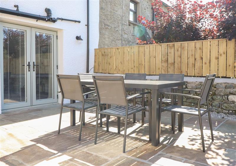 Enjoy a glass of wine on the patio at Ghyll Cottage, Leasgill near Milnthorpe