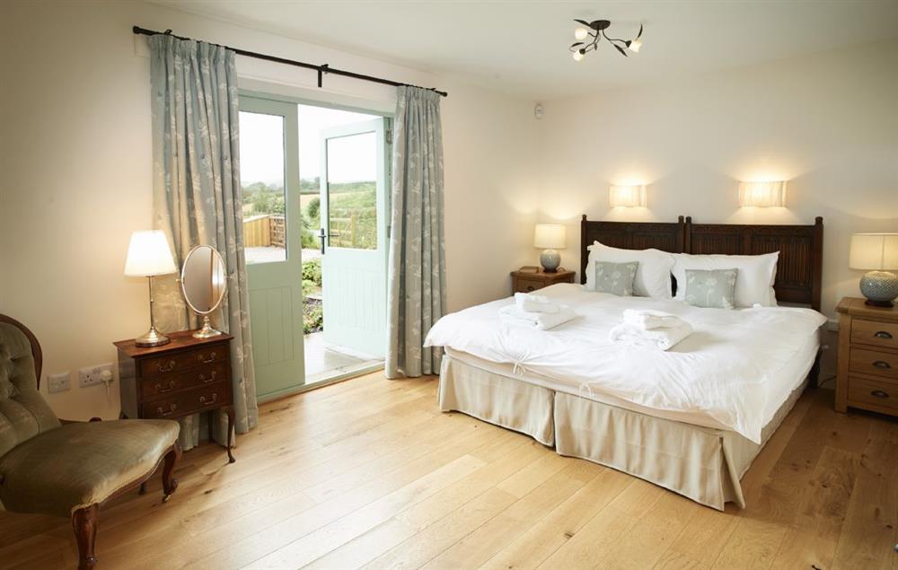 King size bedroom with 6’ zip and link bed and en suite shower room at Gill Beck Barn, Melmerby
