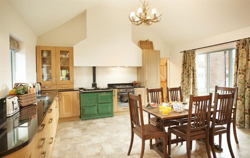Kitchen with large breakfast table and granite topped counters at Gill Beck Barn, Melmerby