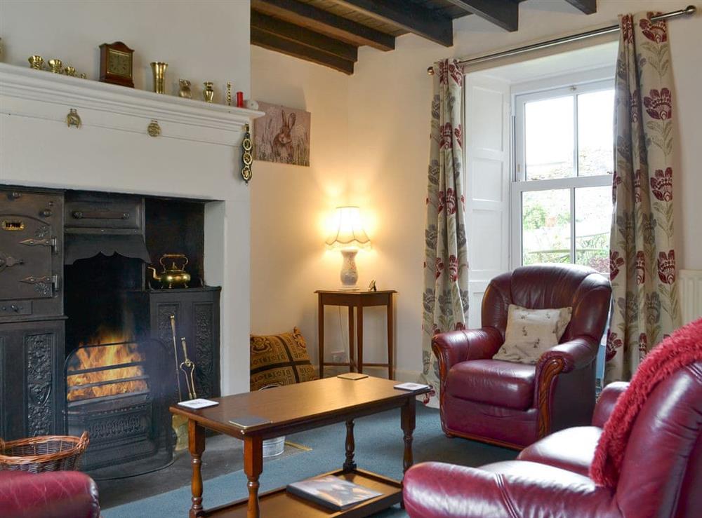 Cosy living room with open fire at Gilmore House in Alston, Cumbria