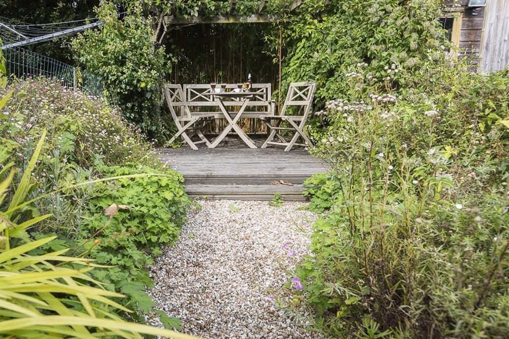 Garden area with decking to the rear of the cottage at Ginn Cottage in , Salcombe