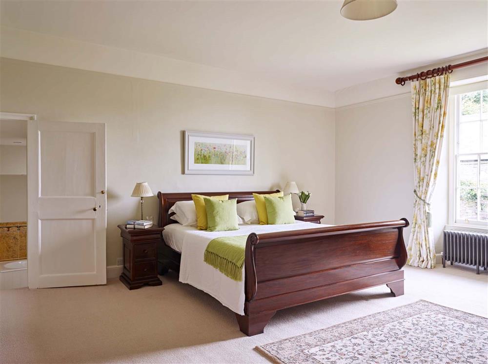 Bedroom one, complete with a 6’ super-king size sleigh bed  at Gitcombe House, Dartmouth
