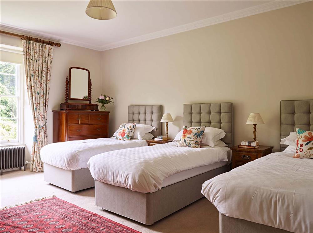 Bedroom two, with triple 3’ single beds, and space for a cot at Gitcombe House, Dartmouth