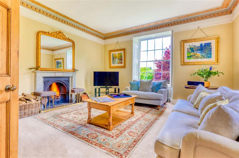 Relax and unwind in the sitting room next to the roaring open-fire  at Gitcombe House, Dartmouth