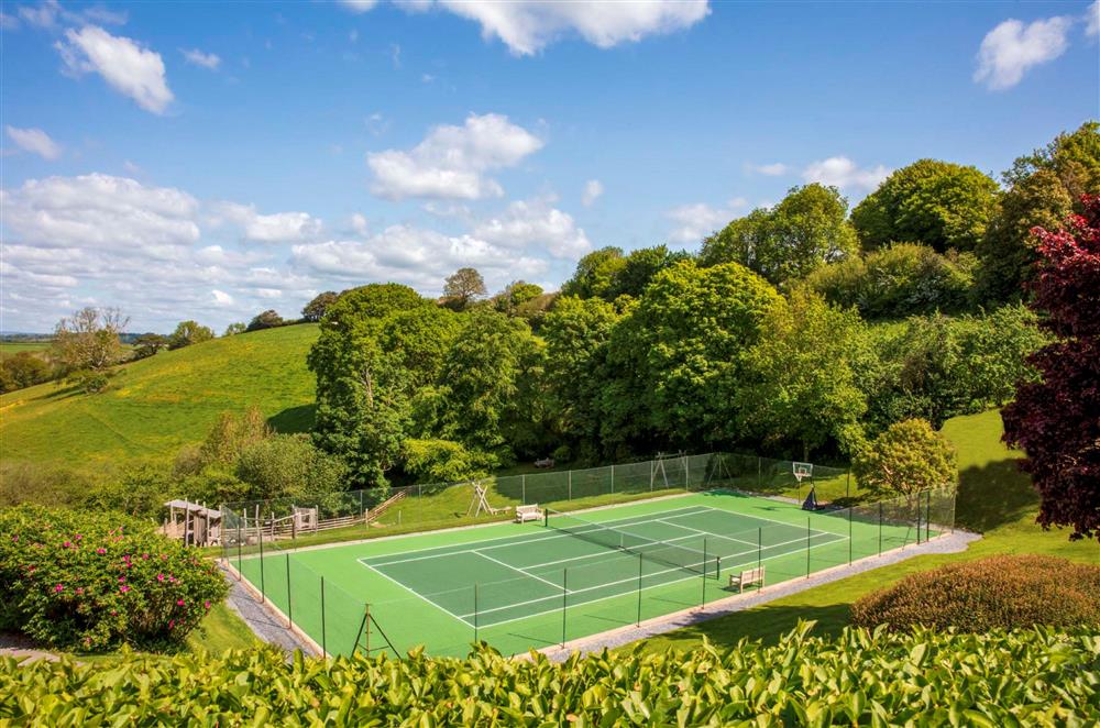 The full-size tennis court, available for guests to use at Gitcombe House, Dartmouth