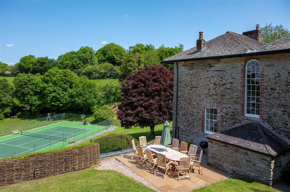 The rear garden, with beautiful views of the full-size tennis court at Gitcombe House, Dartmouth