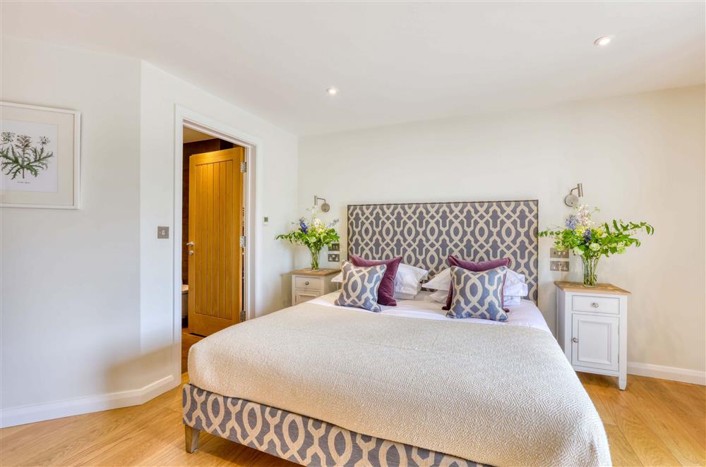 Bedroom four, with a super-king size bed and en-suite shower room  at Gitcombe Retreat, Dartmouth