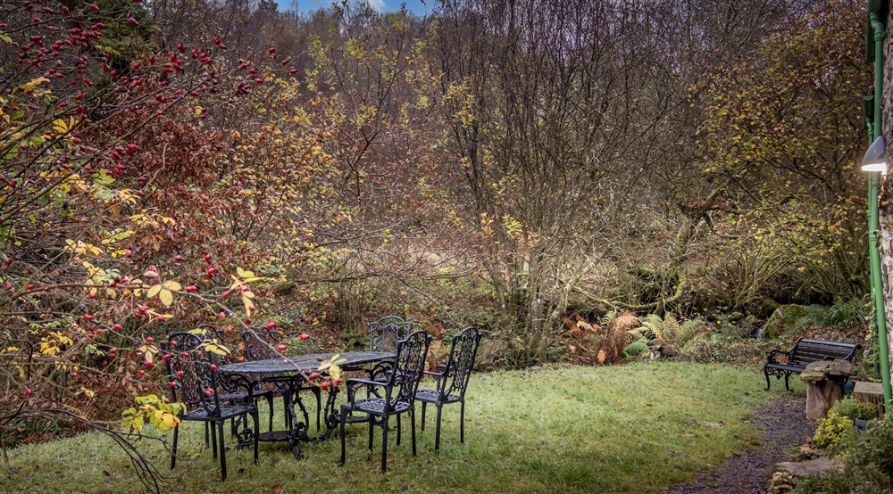 The outdoor seating and open garden at Glan Yr Afon in Dolwyddelan, Gwynedd