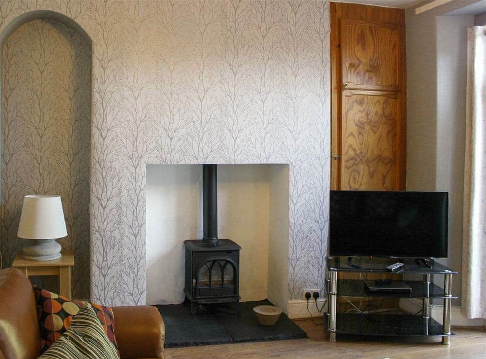 Attractive living room with wood burner at Glaramara in Kendal, Cumbria, England
