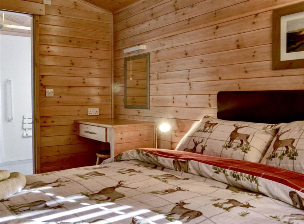 Double bedroom with direct access to the bathroom at Glas Doire Lodge in Glen Roy, near Fort William, Highlands, Inverness-Shire