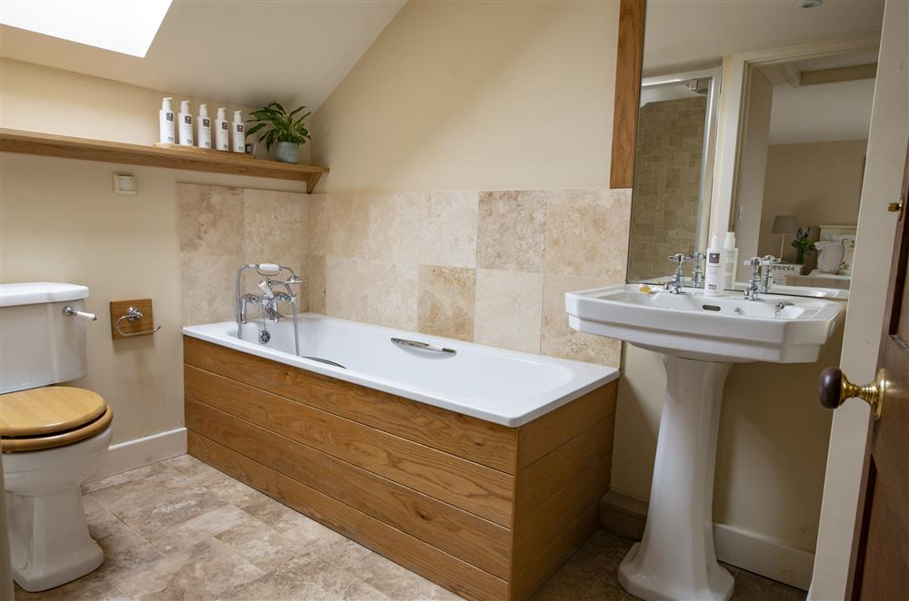 Bedroom one’s en-suite bathroom with a bath and separate walk-in shower at Glassonby Old Hall and Jennys Croft, Glassonby