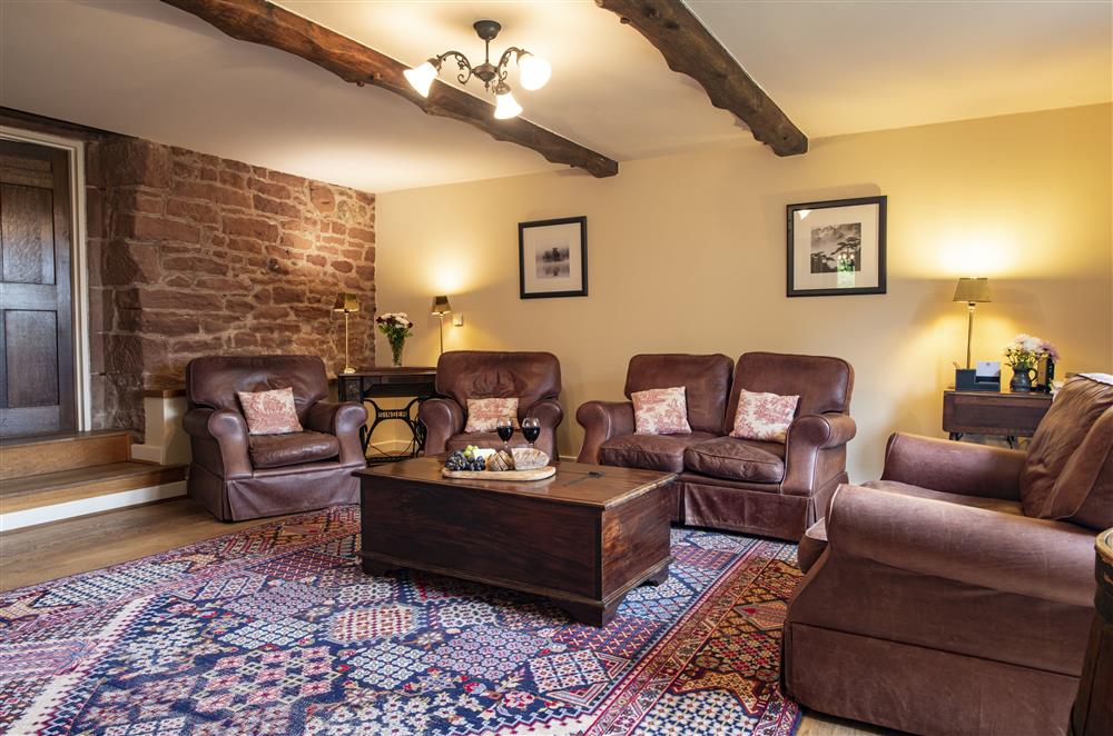 Sumptuous seating and exposed beams in the sitting room at Glassonby Old Hall and Jennys Croft, Glassonby