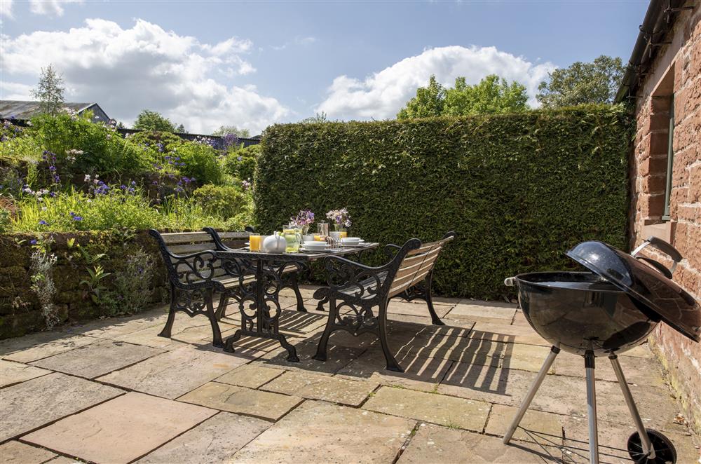 Sunny terrace with Weber barbecue at Glassonby Old Hall and Jennys Croft, Glassonby
