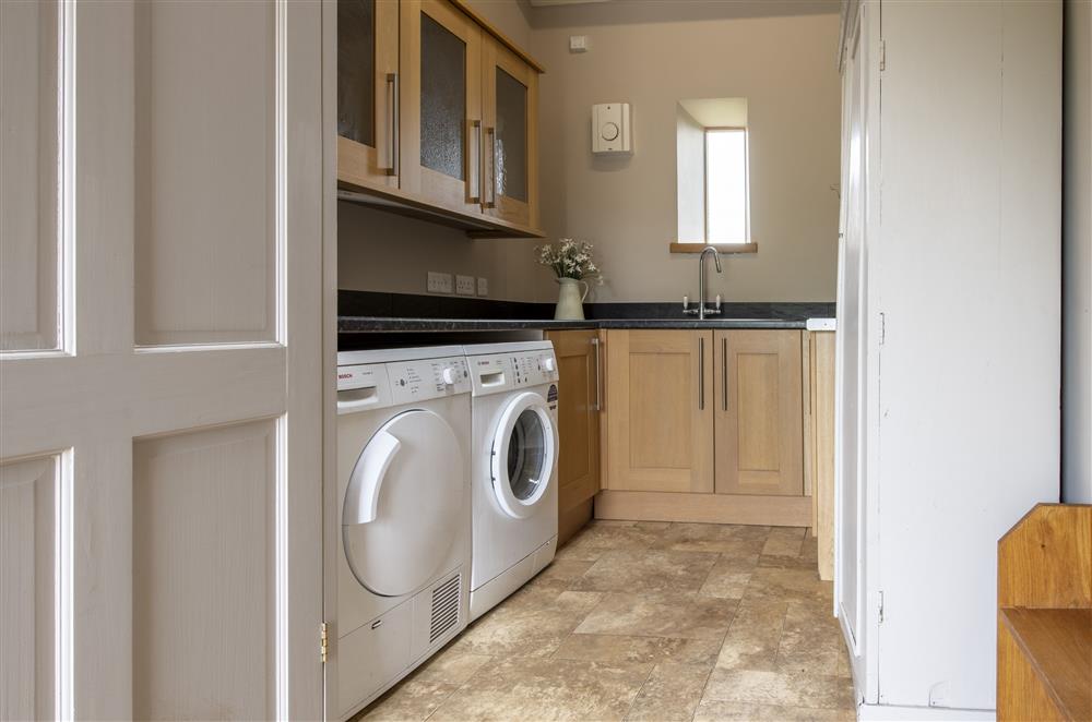 Utility room with washing machine and tumble dryer at Glassonby Old Hall and Jennys Croft, Glassonby