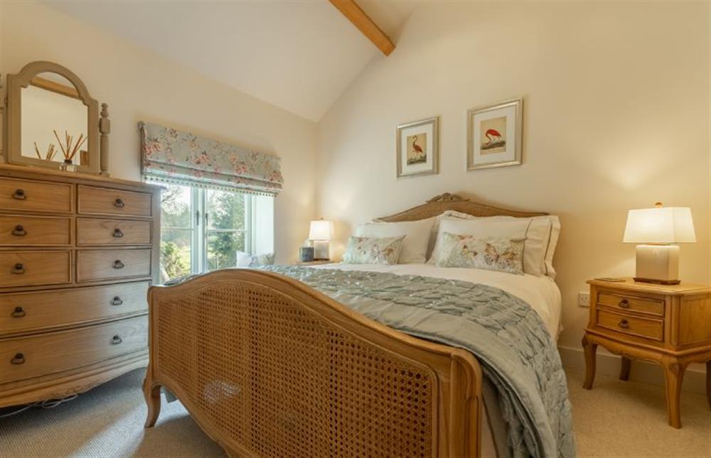 First floor: Bedroom two has double bed and garden views at Glaven Cottage, Letheringsett near Holt