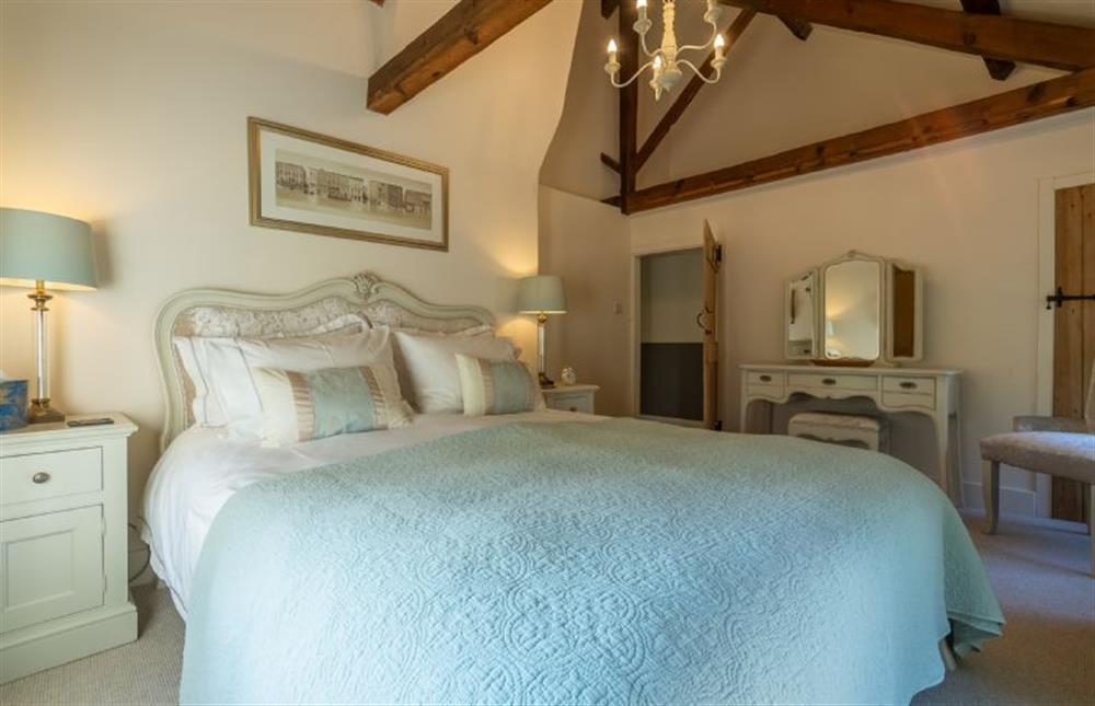 First floor: The master bedroom has king-size bed at Glaven Cottage, Letheringsett near Holt