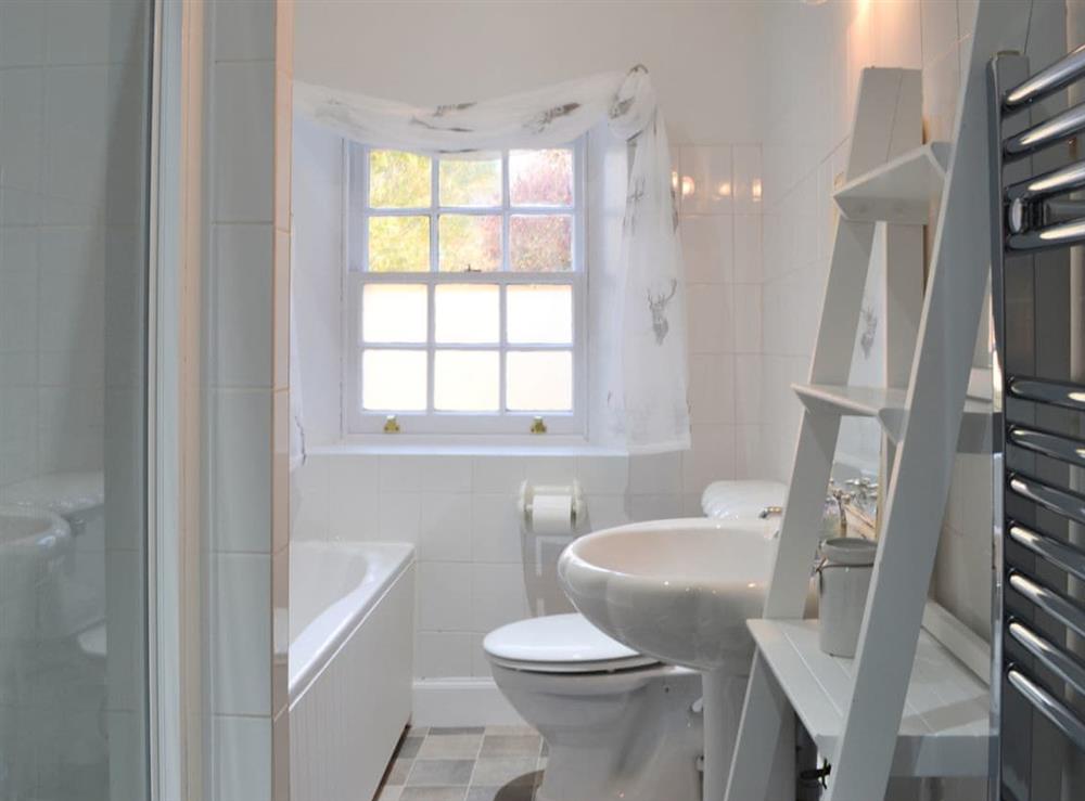 Bathroom with shower cubicle and heated towel rail at Glebe Cottage in Urray, near Dingwall, Highlands, Ross-Shire