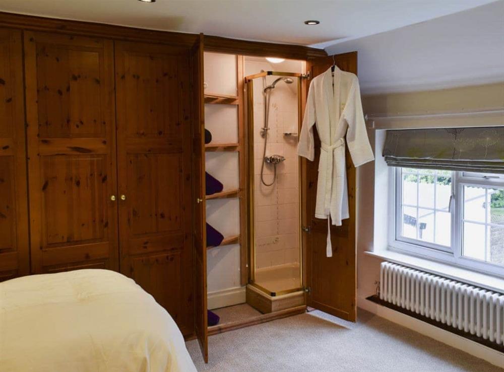 Bedroom with en-suite shower cubicle at Glebe Farm Cottage in Hornby, North Yorkshire