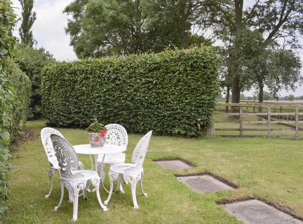 Well-maintained garden with outdoor seating areas at Glebe Farm Cottage in Hornby, North Yorkshire