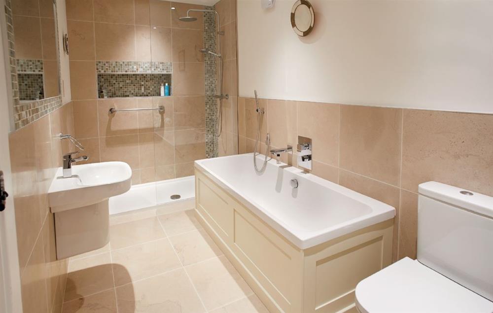 En-suite bathroom with bath and separate rainfall shower at Glen Bank, Appleby-in-Westmoreland