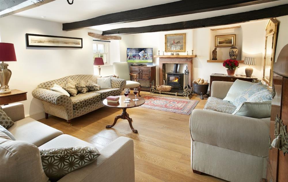 Sitting Room with exposed beams and wood burning stove