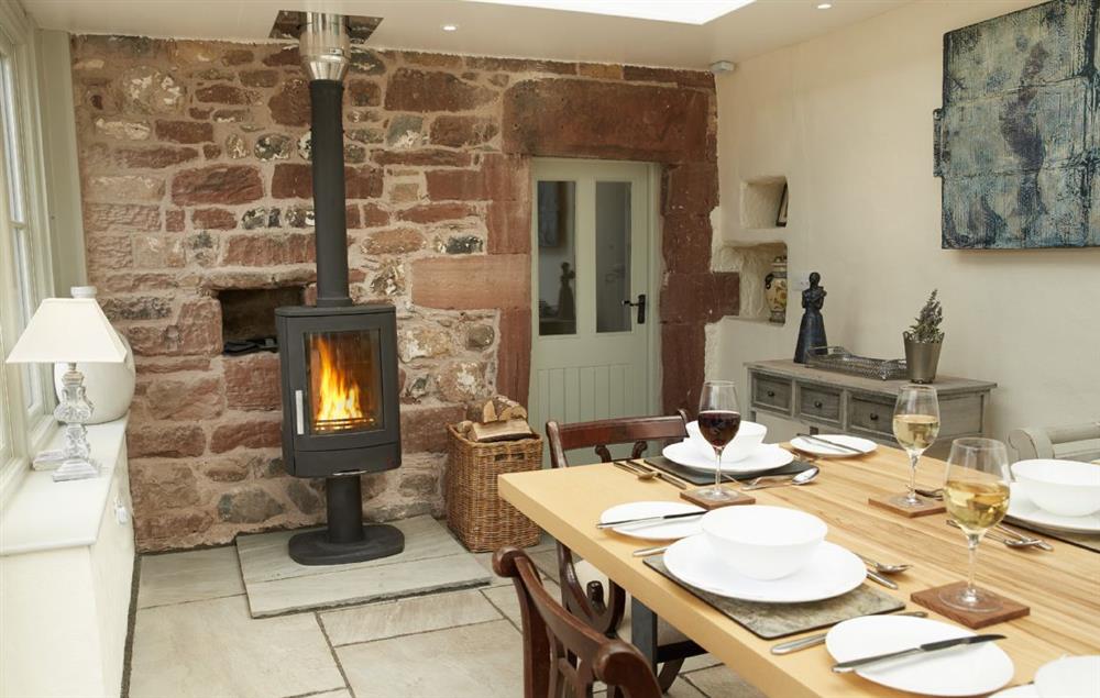 The Orangery with dining table seating 10 and wood burning stove