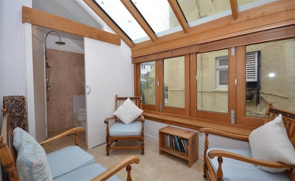 A calming conservatory with wet room en-suite at Glencoe Cottage in Polperro
