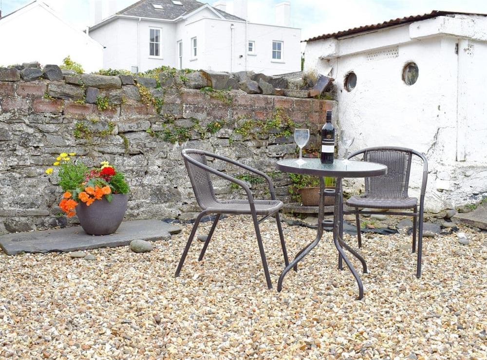 Outdoor furniture on patio within rear garden at Glendower in Aberaeron, Dyfed