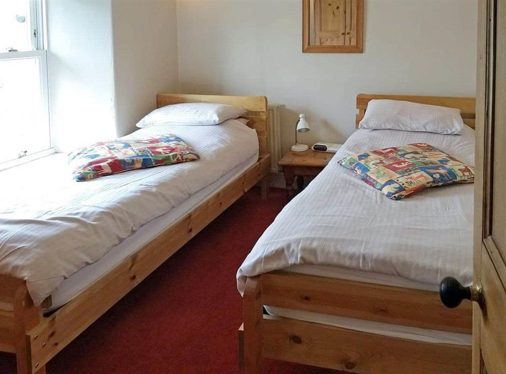 Good-sized twin bedroom at Glenmore Cottage in Ambleside, Cumbria