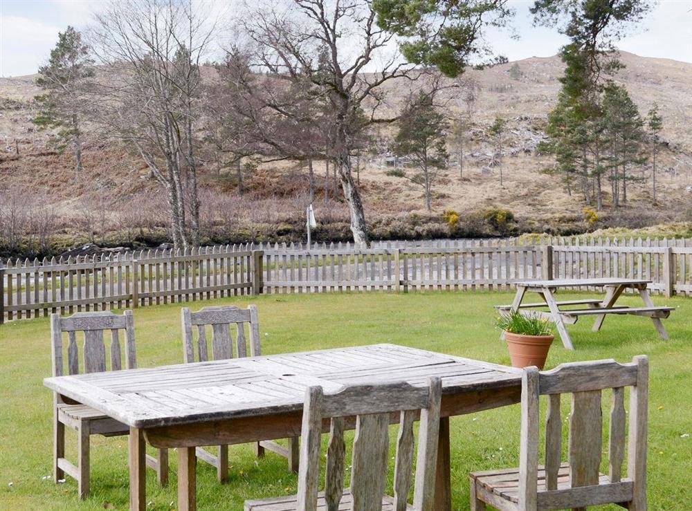 Large enclosed lawned garden with outdoor furniture at Keepers House, 