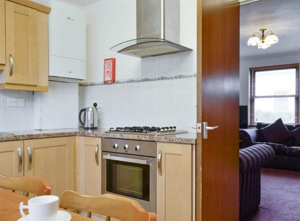 Well-equipped kitchen with dining area at Glenwood in Keswick, Cumbria
