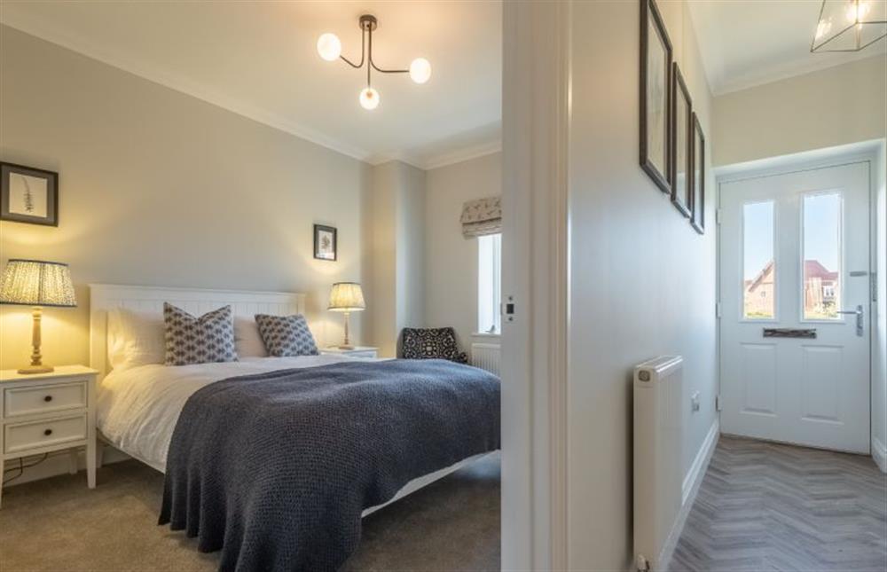 Ground floor: Master bedroom with king-size bed at Glimpse, Hunstanton