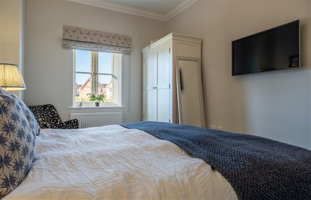 Ground floor: Master bedroom with storage space and television at Glimpse, Hunstanton