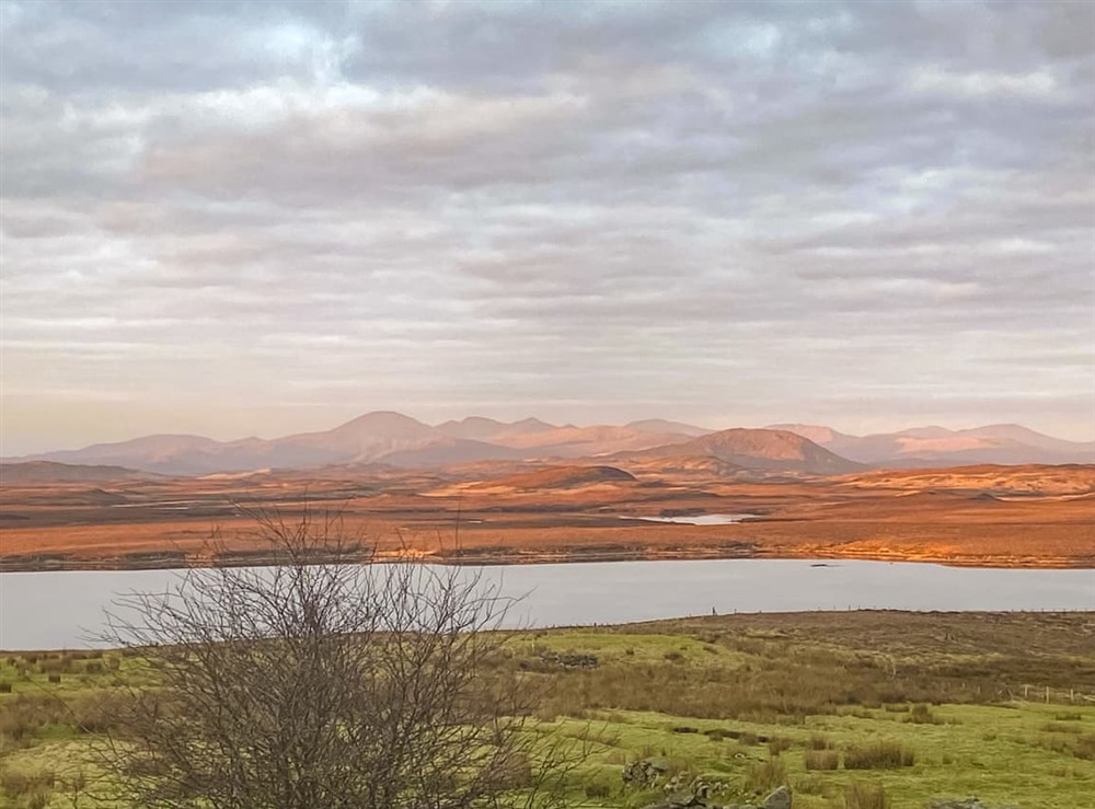 Watch as the sun paints the mountains with colours every morning! at Go Ye Cottage in Achmore, Isle Of Lewis