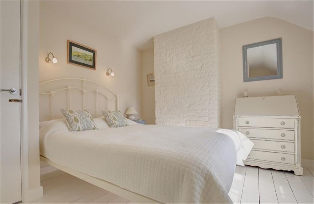 First floor: The bedroom has a king-size bed at Goldfinch Cottage, Burnham Norton near Kings Lynn
