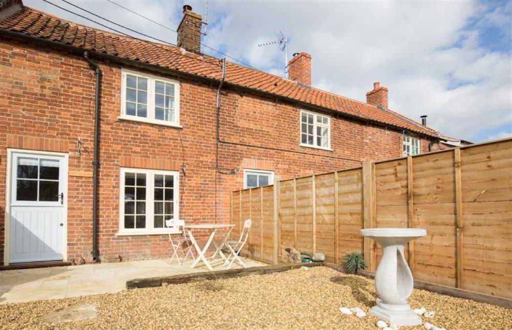 Goldfinch Cottage has south facing patio with seating at Goldfinch Cottage, Burnham Norton near Kings Lynn