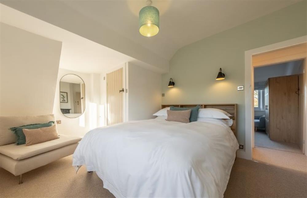 Master bedroom with a king-size bed at Golf Cottage, West Runton near Cromer