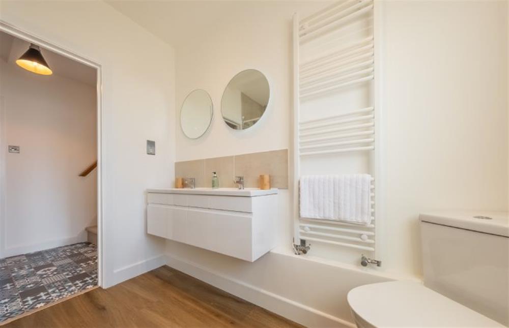 Shower room with twin wash basins, WC and heated towel rail at Golf Cottage, West Runton near Cromer