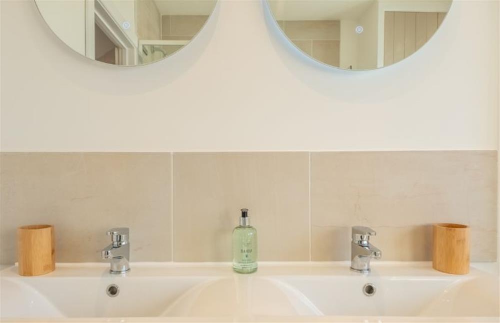 Shower room with twin wash basins at Golf Cottage, West Runton near Cromer