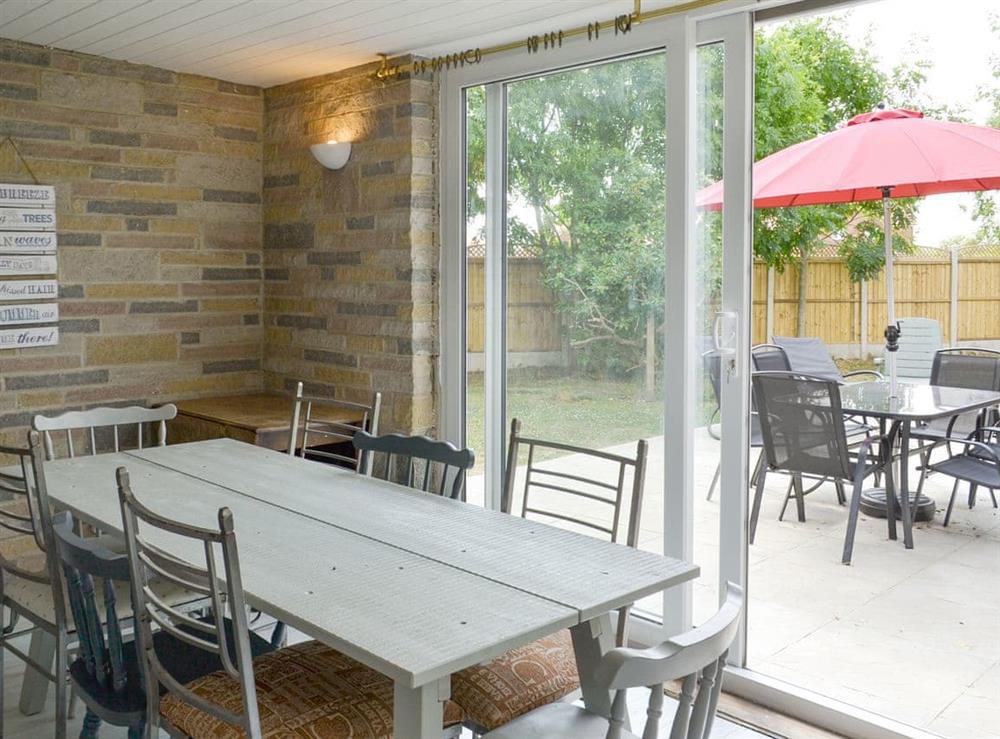 Dining room with patio door to garden at Golf Road in Mablethorpe, near Skegness, Lincolnshire