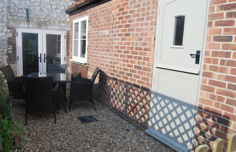 Courtyard area with seating for four at Goose Cottage, Titchwell near Kings Lynn