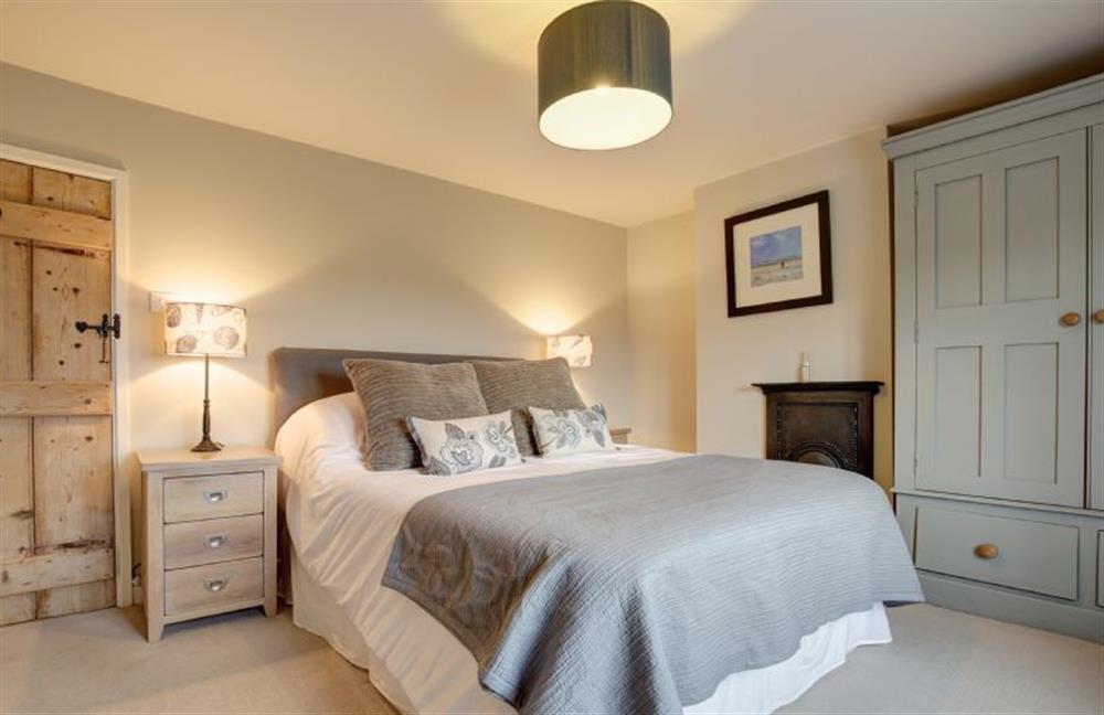 First floor: Master bedroom with King-size bed at Goose Cottage, Titchwell near Kings Lynn