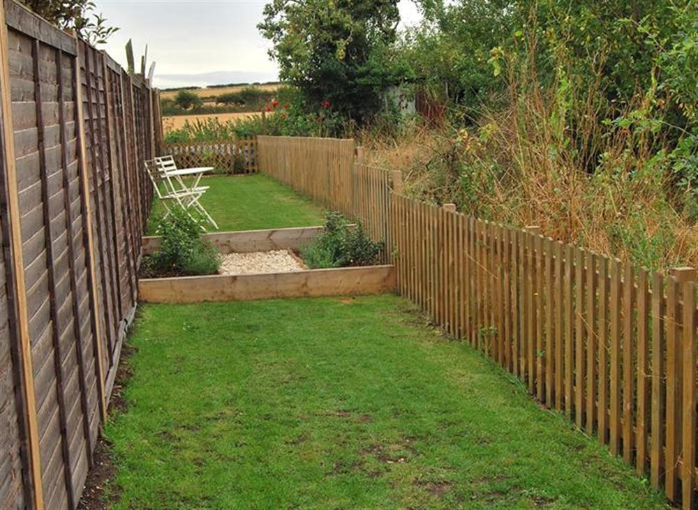 Lawned area with views to open countryside at Goose Cottage, Titchwell near Kings Lynn