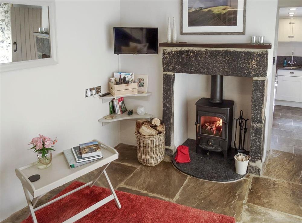 Relax and unwind in this cosy living room with wood burner at Goose Croft in Edale, Hope Valley, Derbyshire