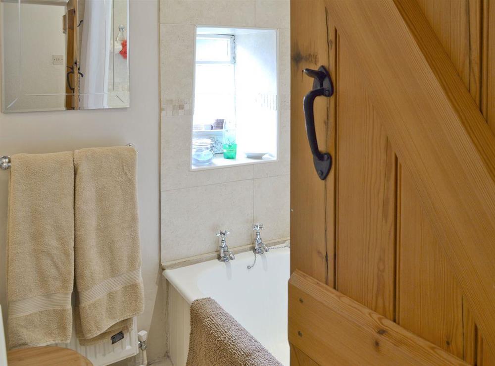Main bathroom with shower over bath at Goose Green Cottage in Baslow, near Bakewell, Derbyshire