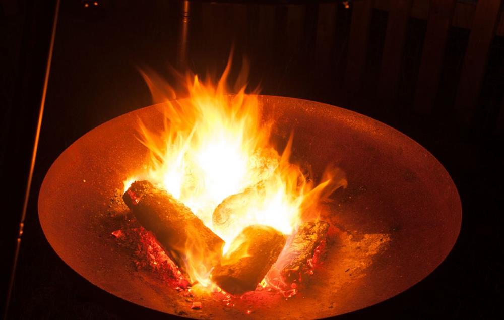 Enjoy a warming firepit for those chilly evenings on the terrace at Goose Run Cottage, Corscombe