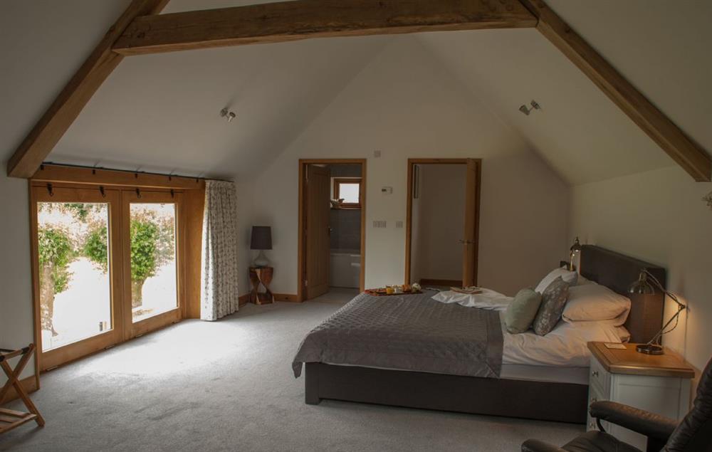 Master bedroom has stunning views to the lake at Goose Run Cottage, Corscombe