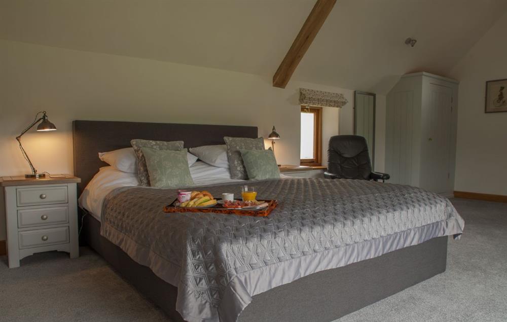 Master bedroom with super king size bed and en suite at Goose Run Cottage, Corscombe