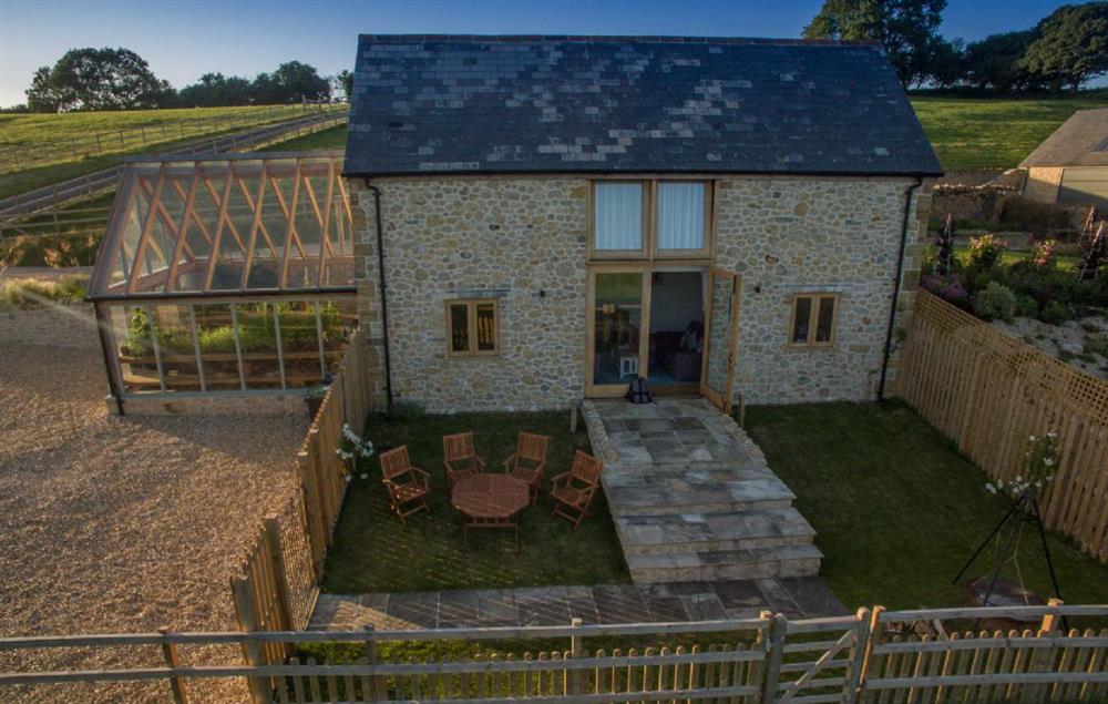 Small enclosed south facing garden with a gate leading out onto the open countryside at Goose Run Cottage, Corscombe