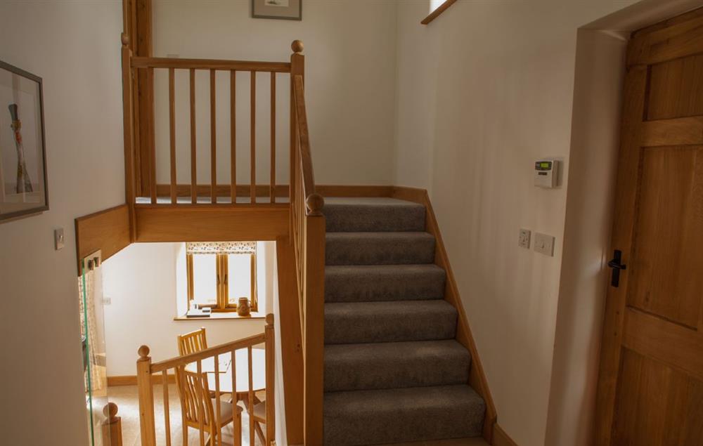 Spacious stairway leading up to the first floor at Goose Run Cottage, Corscombe